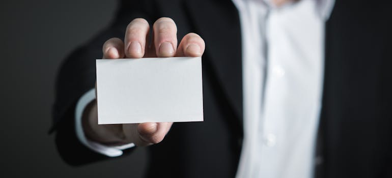 a man holding an empty business card