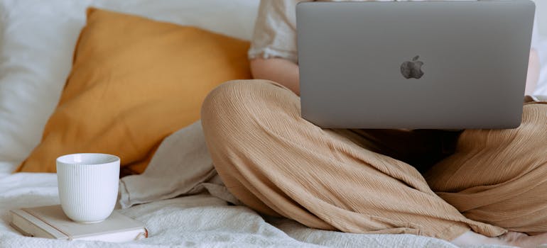 a person writing a positive customer review on their laptop, which is one of the characteristics of a reliable moving company