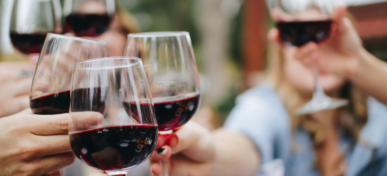 people drinking red wine at one of the best places to buy a vacation home in Northern VA