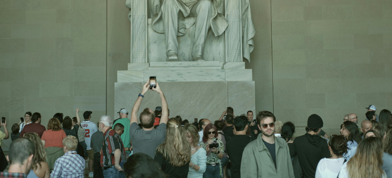 a monument with lots of tourists surrounding it