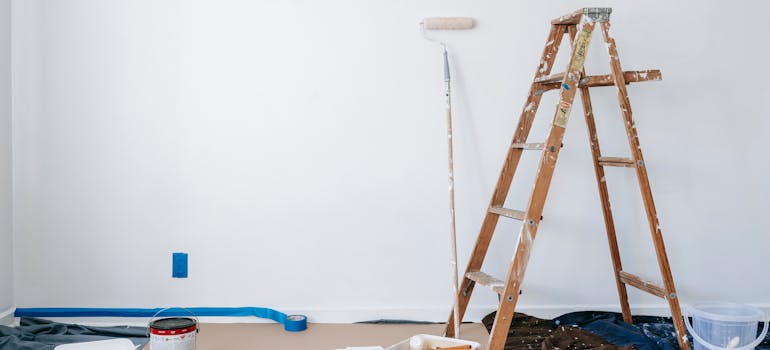 an empty room with some tools and equipment for painting the walls