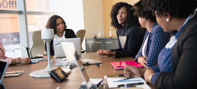 some women having a meeting in a big conference room 