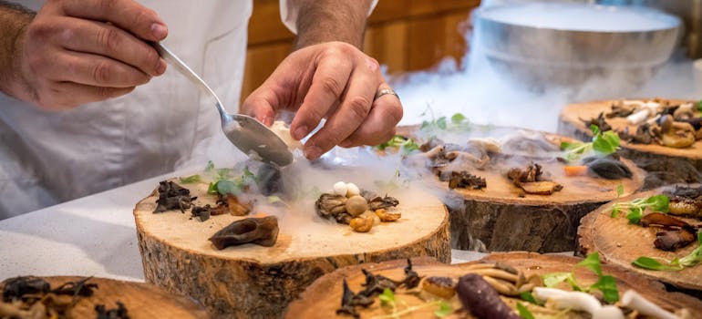 a chef decorates high-end dishes for his guests