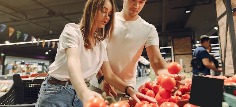 two people looking at the prices in a supermarket to calculate the cost of living in Maryland