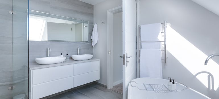 a modern fully-stocked white bathroom, which is something you can expect in a fully furnished rental