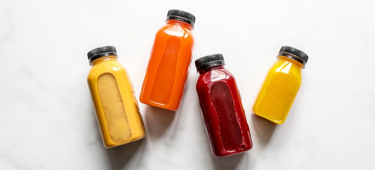 four bottles of smoothies which are among the healthy snacks for your moving day