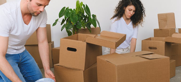 two people packing boxes together