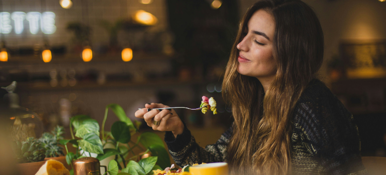 a woman enjoying her meal in a modern restaurant