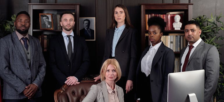 a group of men and one woman in an elegant office 