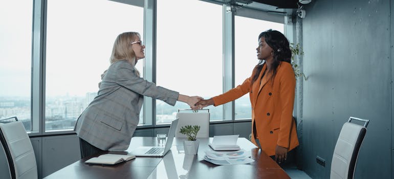 two women shaking hands