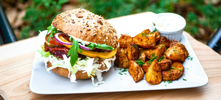 a vegan burger and potatoes on the side