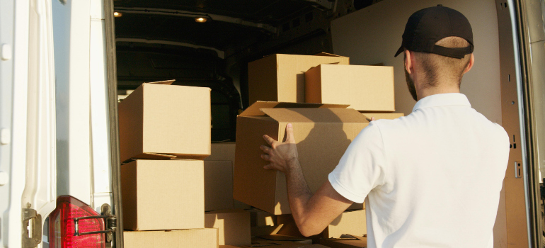 man putting boxes into a van