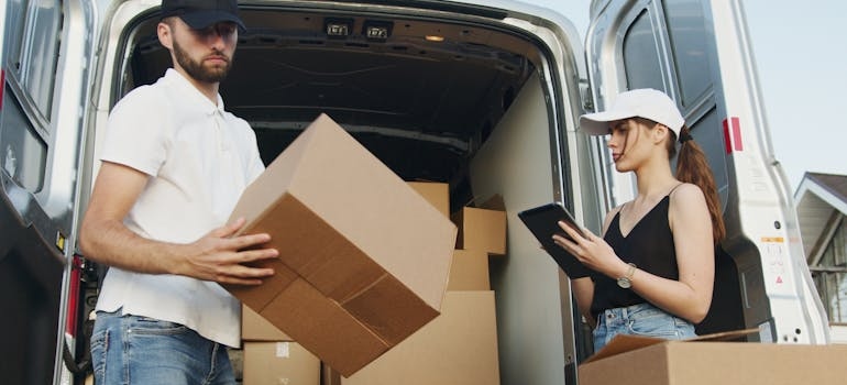 Movers getting boxes out of a moving truck.