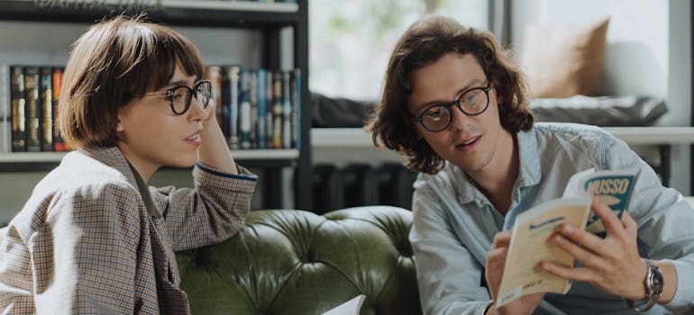 a man and a woman bonding over a book during a book club meeting