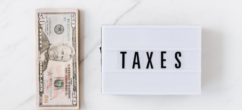 The word "taxes" next to a bunch of dollars