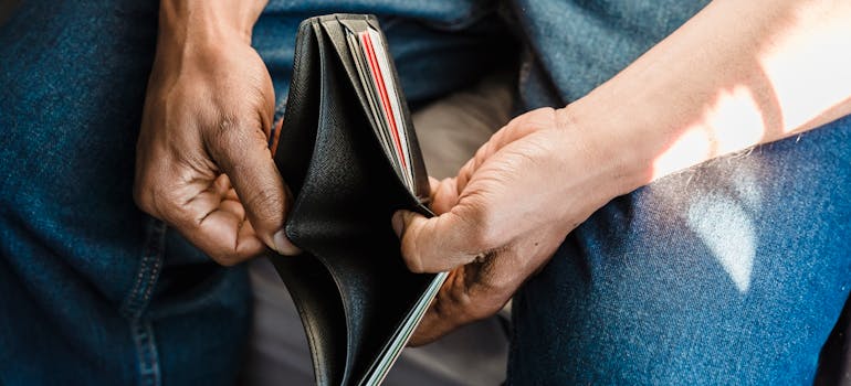 a man opening up an empty wallet