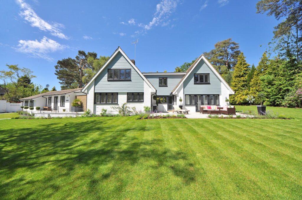 a blue house with grass yard