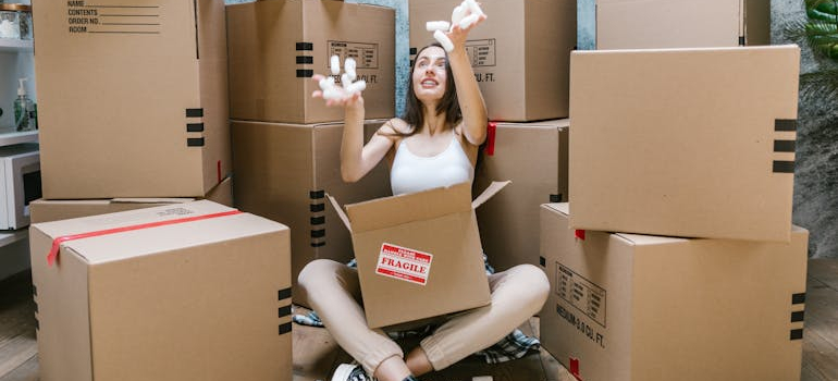 a person sitting in between boxes