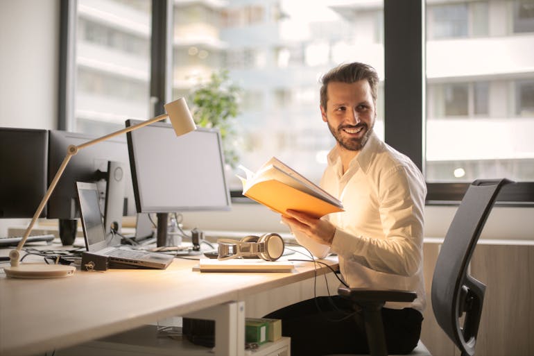 Man holding a book and reading a text in the background that says Maryland cities for singles