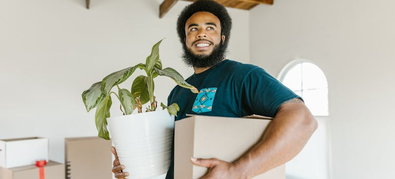 a mover holding a pot and a box