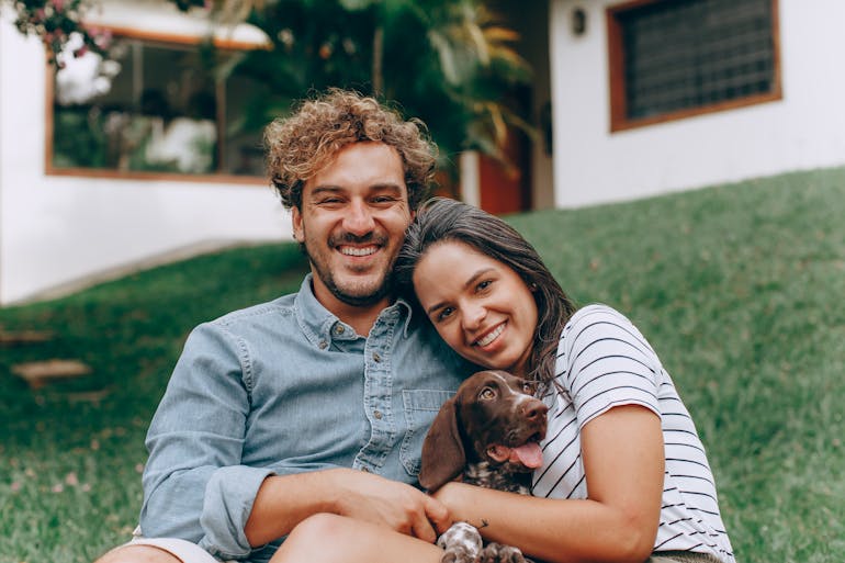 People smiling with the dog and thinking about affluent living in DC