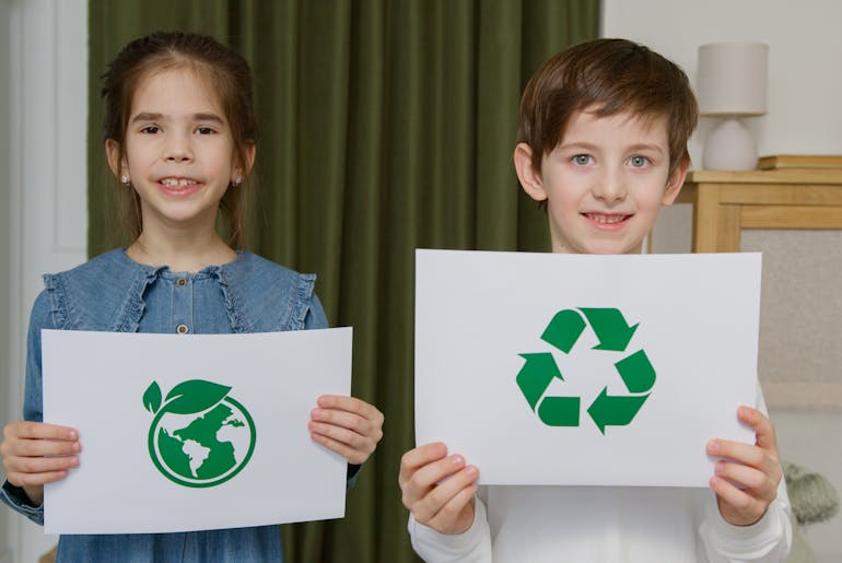 Kids holding recycle sign 