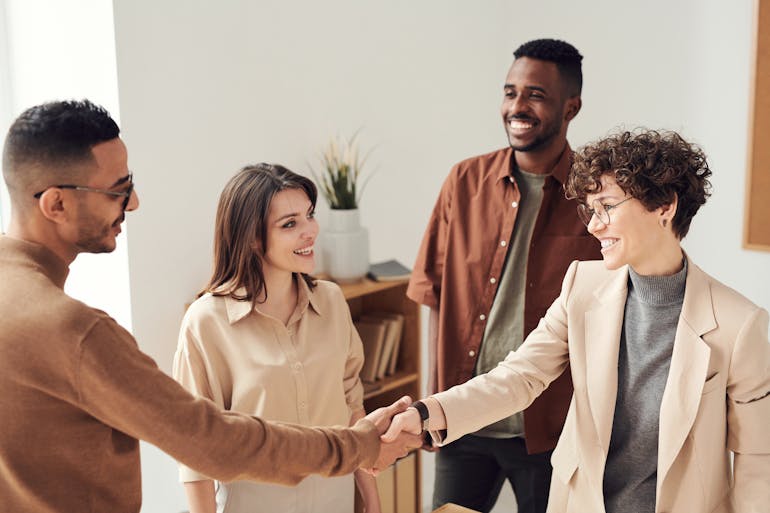 Photo of people doing handshakes and thinking about successful corporate relocation in Arlington