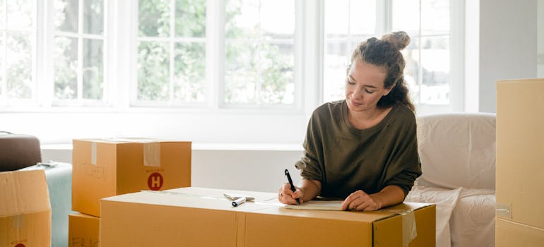 a person labeling a box, balance your time effectively while relocating