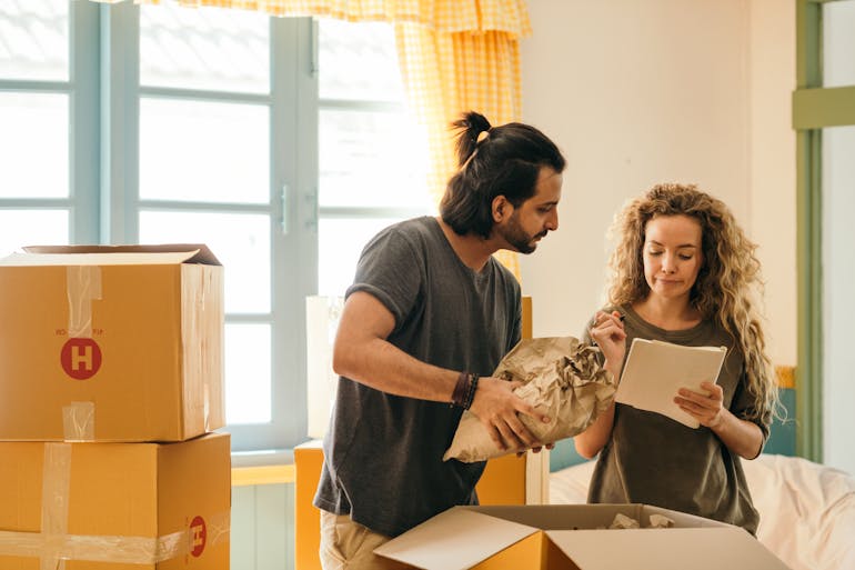 Happy couple unpacking and talking about moving from Alexandria to Annapolis