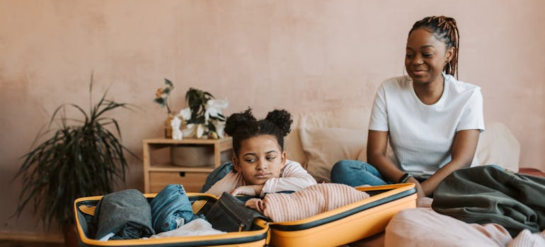 a mom and a daughter packing