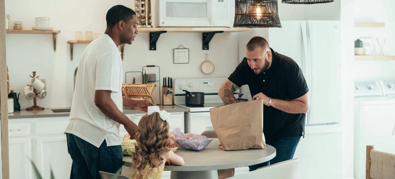 Men Unpacking Groceries at the Table 