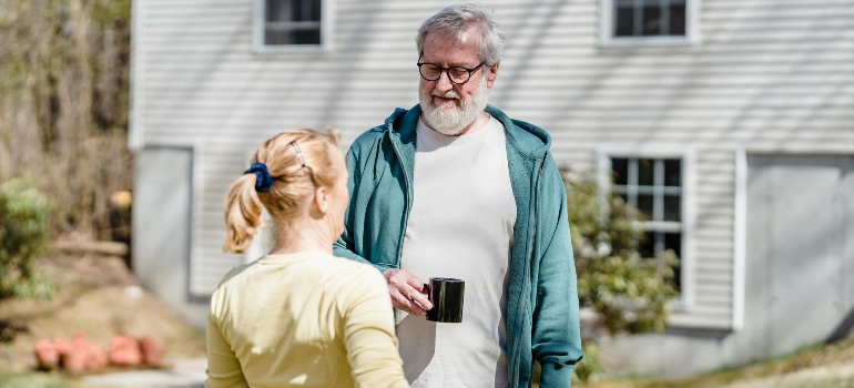 A woman approaching new neighbors with confidence after moving 