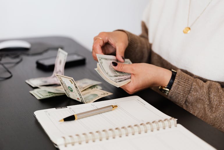 Woman counting money and thinking about move from Manassas to Annapolis