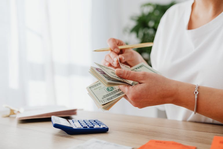 Woman counting money and thinking about leaving Fredericksburg for Clinton