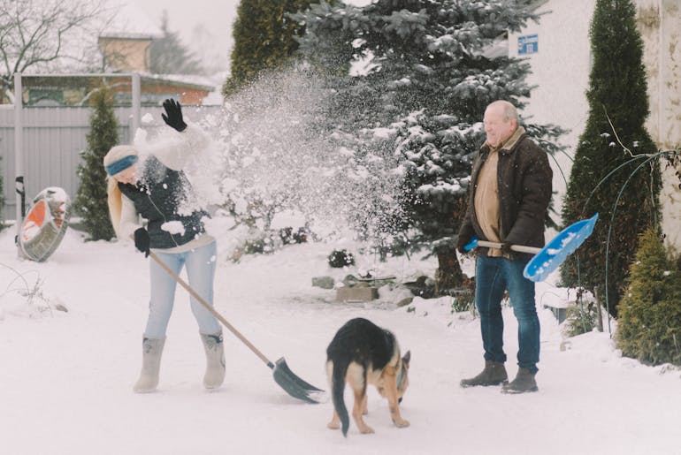 Couple shoveling snow 