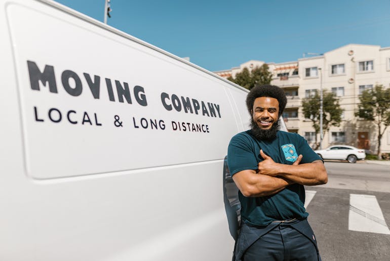 Man standing in front of a van and thinking about the relocating luxury items