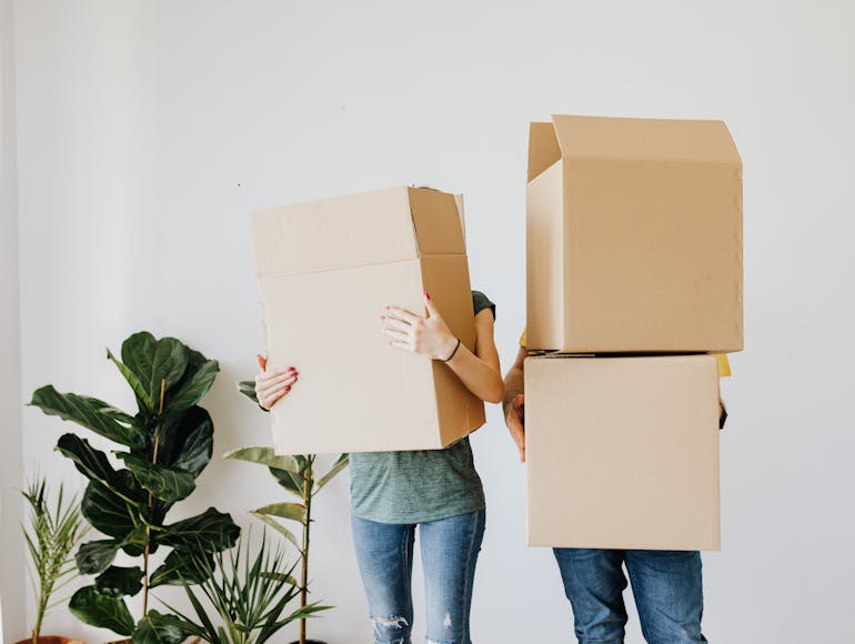 People holding boxes and thinking about small property move