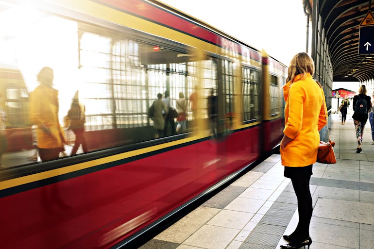 Woman standing in front of a train