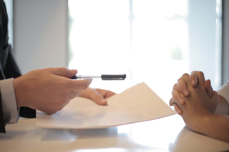 Man giving paper to a woman 