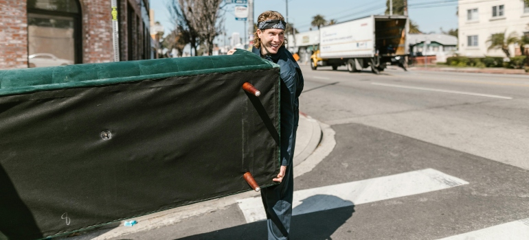 Man holding a sofa