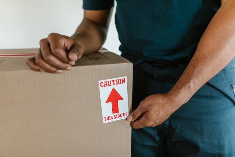 Man putting sticker on the box