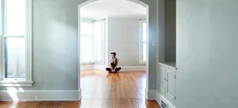 Person sitting in an empty home before selling your home in Virginia
