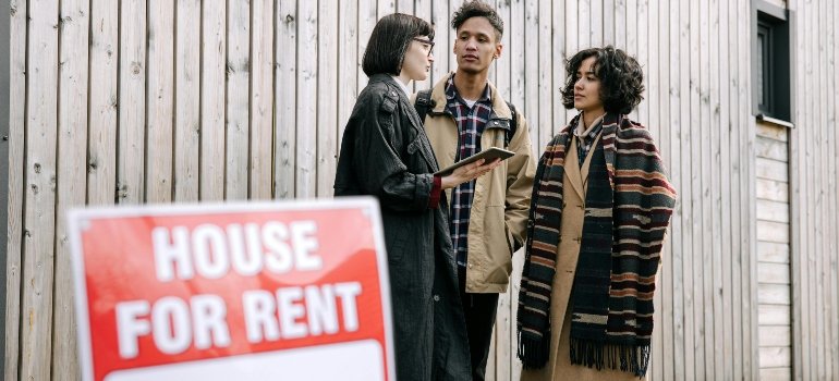 An agent walks a couple through the process of renting a house.