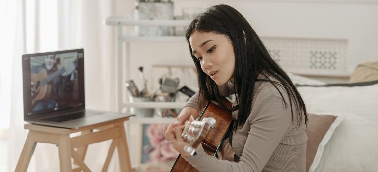 a girl living in DC as a student, playing guitar