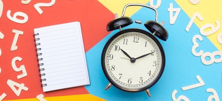 a clock and an empty notebook ready to make a plan for moving private practice in MD