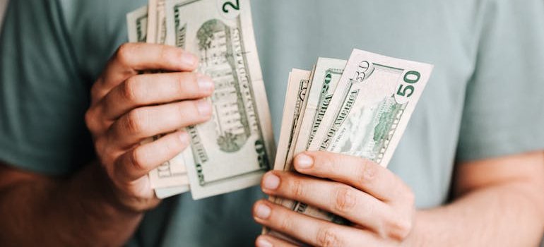 a person counting their money they have ready for budget-friendly homes in Maryland