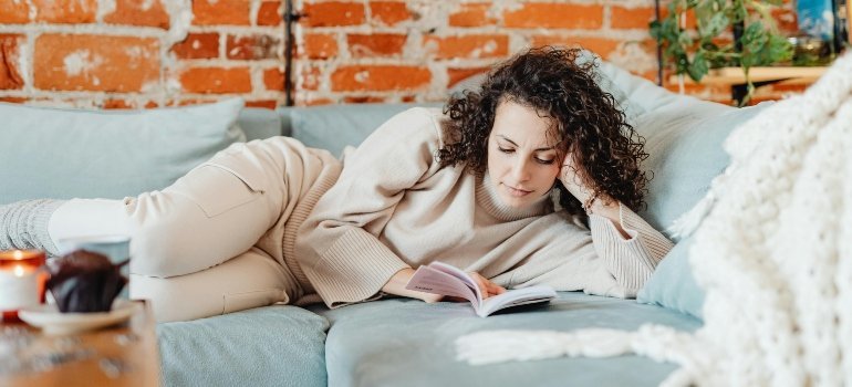 A woman resting after learning how to make your new home safe and comfortable after moving.