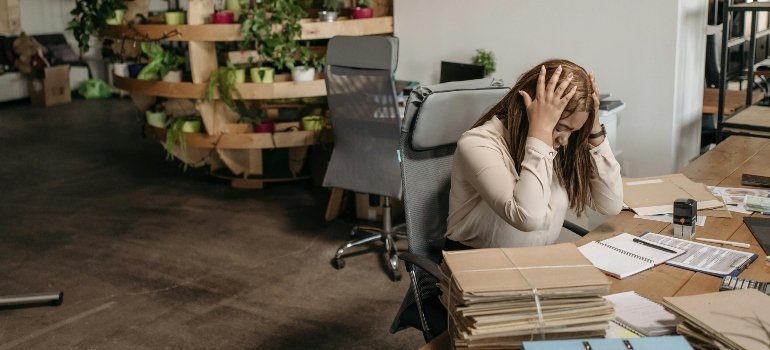 A stressed woman relocating after losing a job.