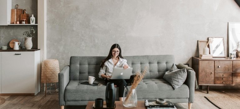 A woman working after learning how to make your new home safe and comfortable after moving.