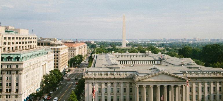 A cityscape view of Washington, D.C. featuring the Washington Monument and surrounding historic buildings.